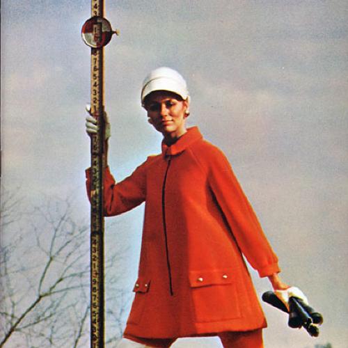 Annual Reports and Corporate Communications depicts: A fancy well dressed woman poses and holds some sort of tall measuring device outdoors 