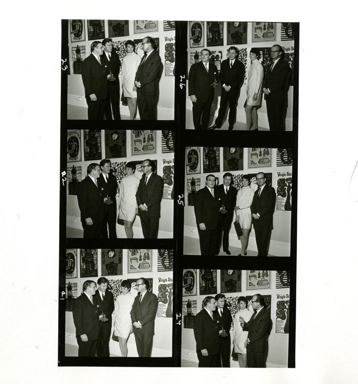 Photographic Materials depicts: A two-by-three grid of six photos of three men and one woman standing in front of artworks