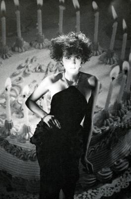 Announcements and invitations depicts: black and white photograph of a woman in front of a giant birthday cake with candles
