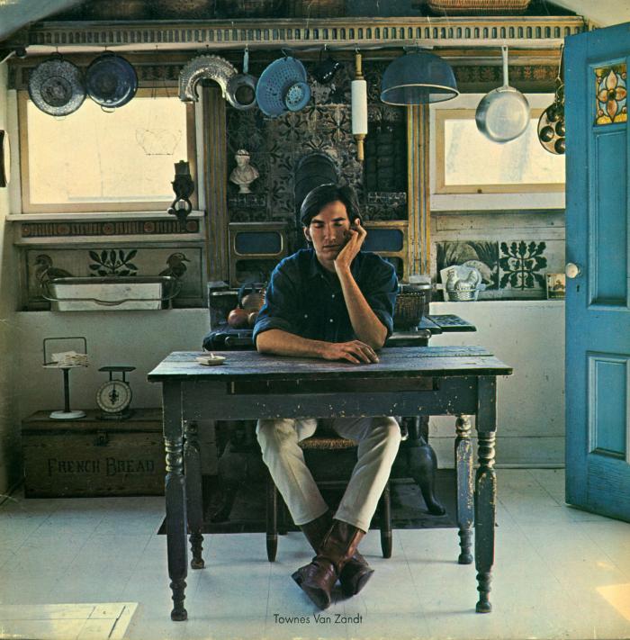 Album Covers depicts: photograph of Townes Van Zandt sitting at a kitchen table with one hand on his cheek. Pots hang from a rack behind him.