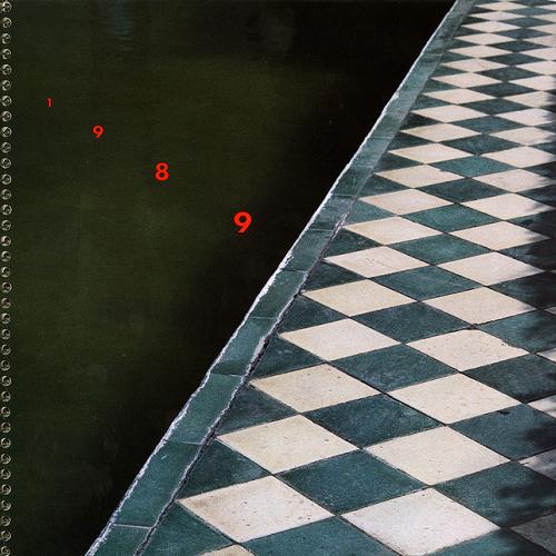 Calendars, Posters depicts: A diamond walkway seen over a black background, int the black "1989" is written in red in a diagnol 