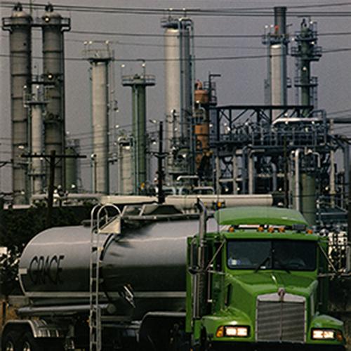 Booklet/Brochure depicts: An 18 wheeler seen in front of industrial buildings and machinery 