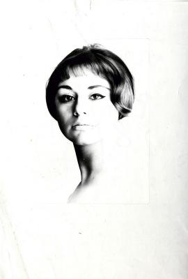 Photographic Materials, Photographic Materials depicts: Black and white headshot woman with ear length brown hair and a long neck