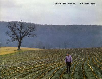 Annual Reports and Corporate Communications depicts: A man smoking a pipe walks through a field of recently harvested crops, a mountain and bare tree is seen in the background 