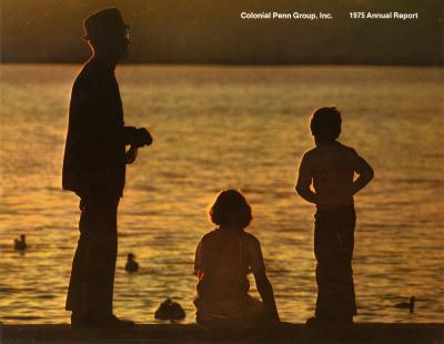 Annual Reports and Corporate Communications depicts: A man in a suit and hat and two small kids are in front of a pond with ducks, they are slightly silhouetted by the sun