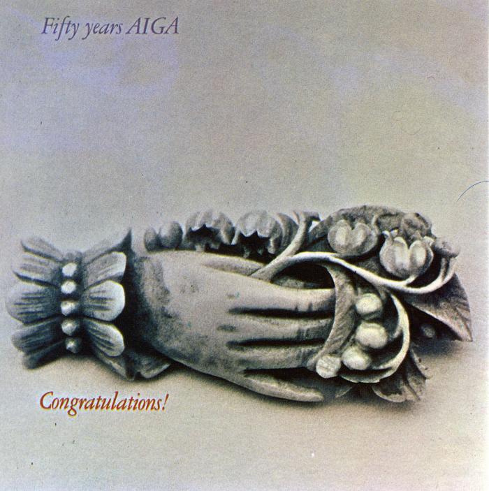 Cards depicts: A silver broach of a hand holding a bunch of flowers 