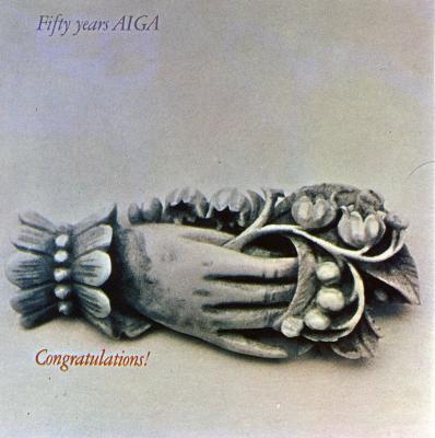 Cards depicts: A silver broach of a hand holding a bunch of flowers 