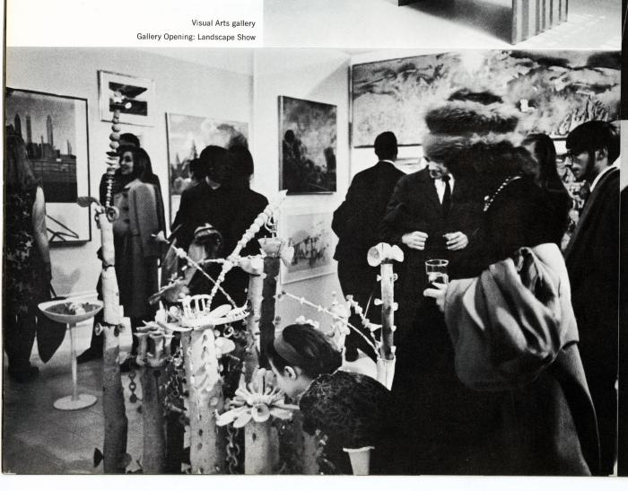 Photographic Materials depicts: People in gallery viewing hung artworks and sculpture