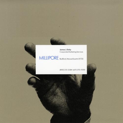 Graphic Standards Manuals, Logos and identities depicts: A hand holding a Millipore business card 