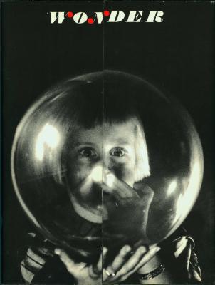 Serial Publications depicts: Figure is shown chest up holding a glass orb in front of their face, through it we see their eyes but their nose and mouth are obscured 