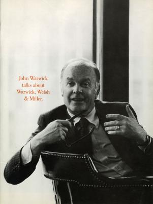 Booklet/Brochure depicts: John Warwick in a suit turned around in a chair holding a pair of glasses, gesturing 