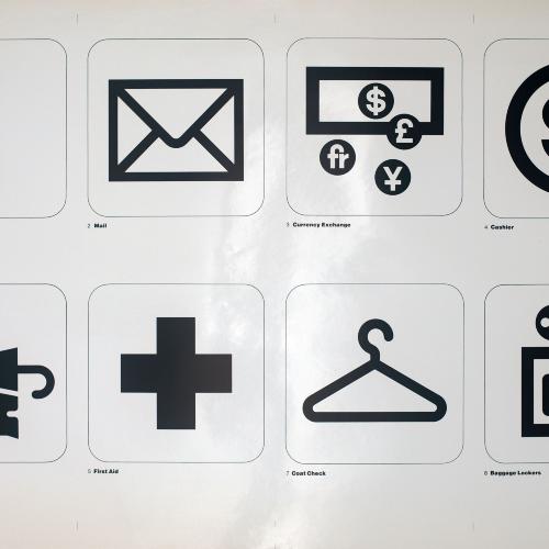 Posters depicts: two by four grid of transportation symbols: telephone, mail, currency exchange, cashier, lost and found, first aid, coat check, baggage lockers