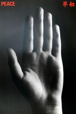 Posters depicts: Black and white photograph of a hand raised, palm forward