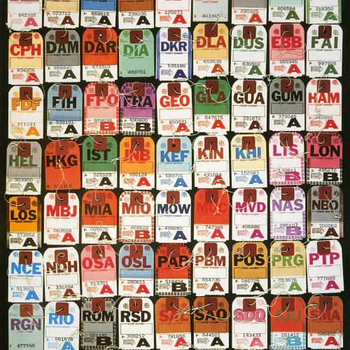 Colorful 1970s era airport baggage claim tags arranged in a grid