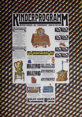 Posters depicts: Newspaper program with various cartoon illustrations of different figures sitting on couches and chairs, and groups of small figures on a table and in a cabinet