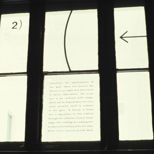 Photographic Materials depicts: color slide of artworks installed in a gallery, on windows
