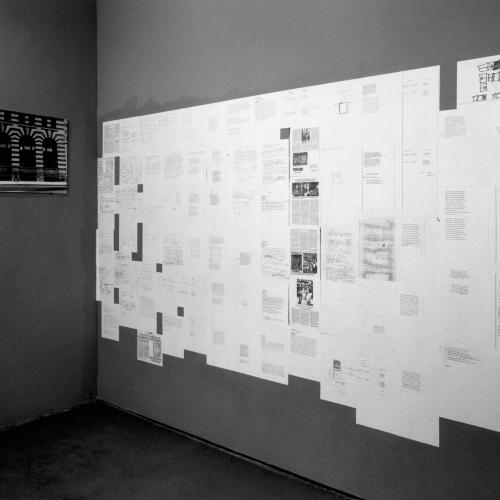 Photographic Materials depicts: black-and-white photographic prints of artworks installed in a gallery