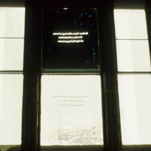 Photographic Materials depicts: color slides of artworks installed in a gallery, on windows
