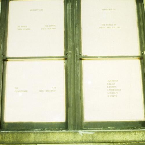 Photographic Materials depicts: color slide of artworks installed in a gallery, on windows