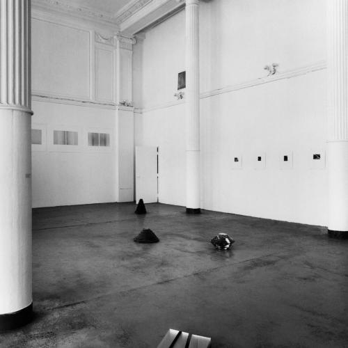 Photographic Materials depicts: black-and-white photographic prints of artworks installed in a gallery