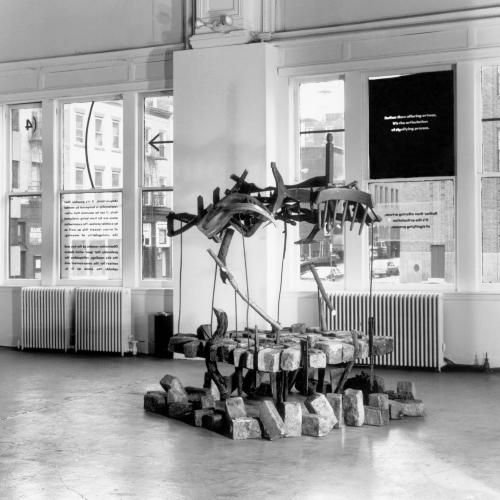 Photographic Materials depicts: black-and-white photographic prints of artworks installed in a gallery