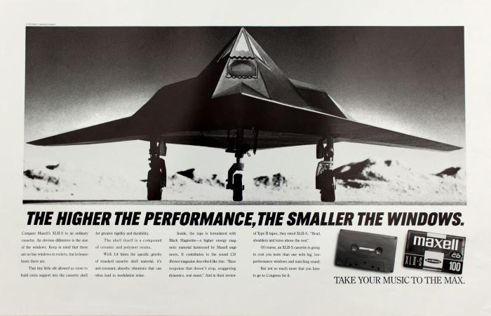 Advertisements depicts: Geometric modern fighter pilot on the ground facing the camera, two casette tapes, one plain black, the other with a Maxwell label sit in the bottom right corner