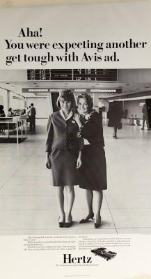 Advertisements depicts: Two female flight attendants smiling in an airport 
