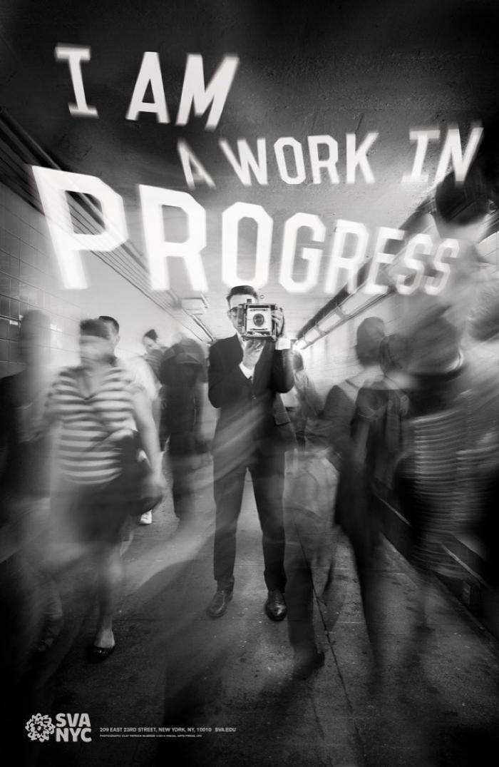 Posters depicts: Blurred black and white photograph of a man in a suit taking a picture of the viewer surrounded by a fast-moving crowd in the subway. Text appears above the crowd in white.