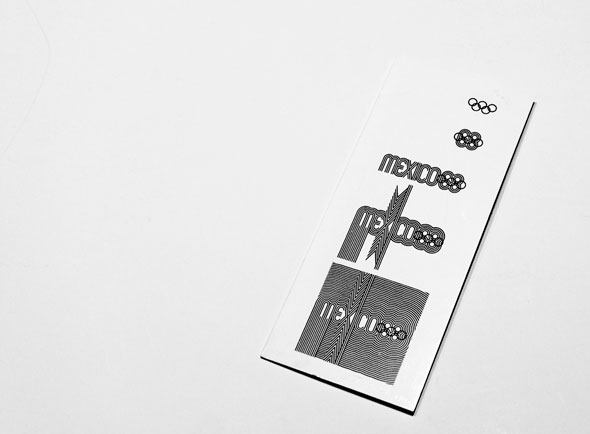 Brochure on a white table, showing various black and white geometric forms