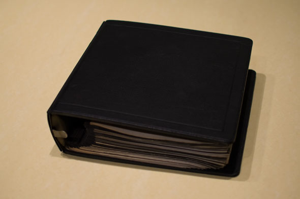 Color photograph of a black binder on a table