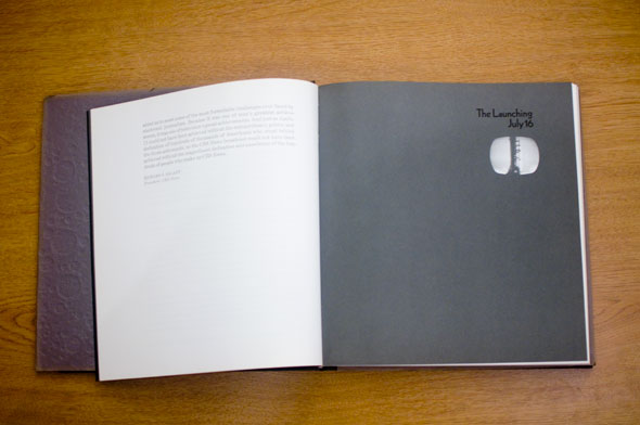 Book opened to show spread; left page is white with black text, right is grey with the header "The Launching July 16"