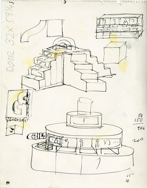 A rough pen sketch on a stained white paper. The sketch is planing layout, some of the drawings is hard to make out what it is. There us also dimension, numbers, random shapes on the sides of the paper. On the top right is a small cubby design. Below is big design of four set staircase going up to the same platform that has a rainbow on top. On the bottom is a design for what looks like a front desk. It has a cylindrical pyramid shape. 